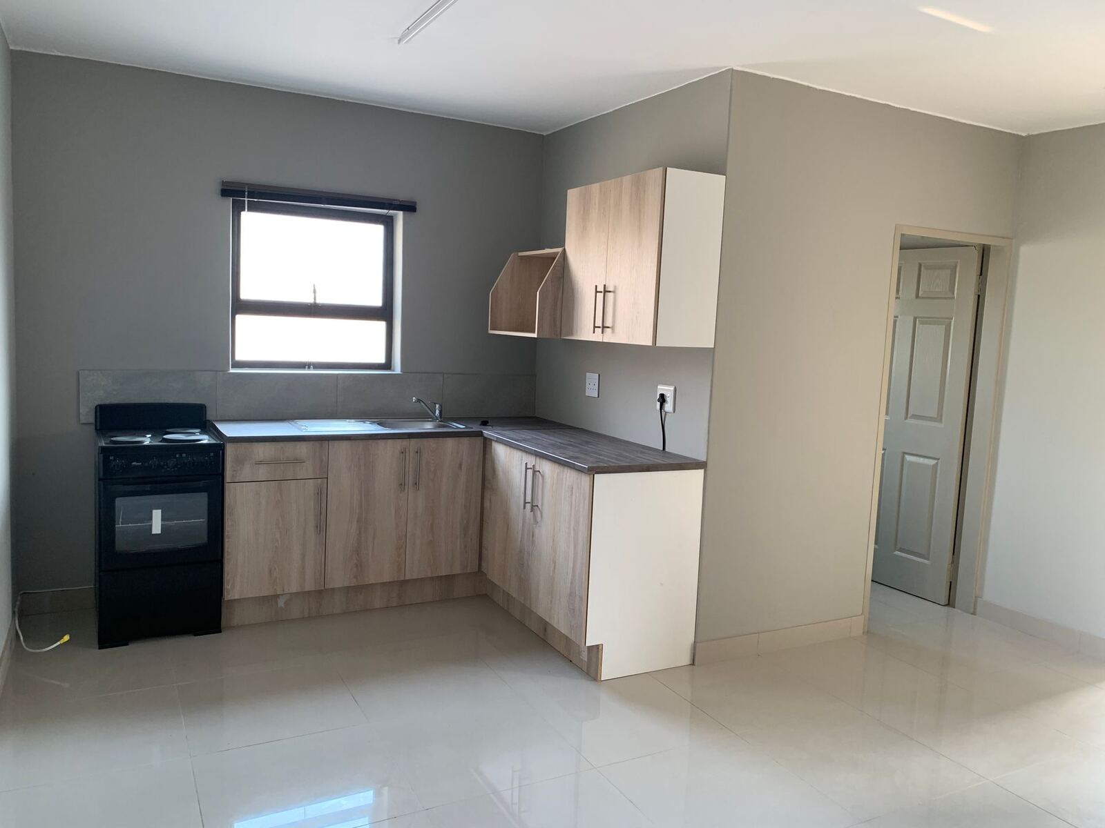 Kitchen with stove, sink and wall cupboards